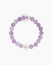 A bracelet of lavender crystal beads with a mother-of-pearl crescent charm cradling a soft rose crystal