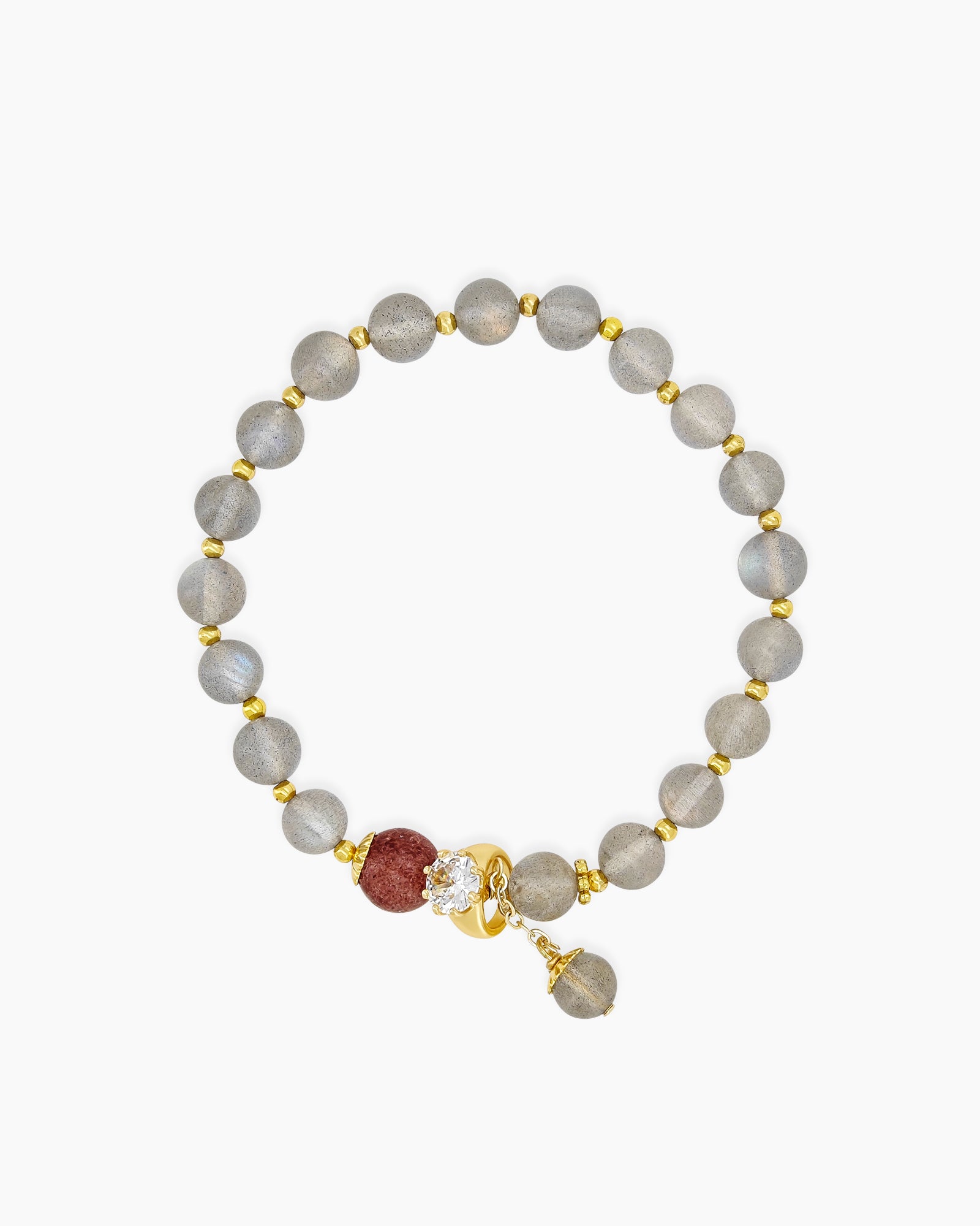 A bracelet of hand-strung natural moonstone beads with a single strawberry quartz bead and golden accents