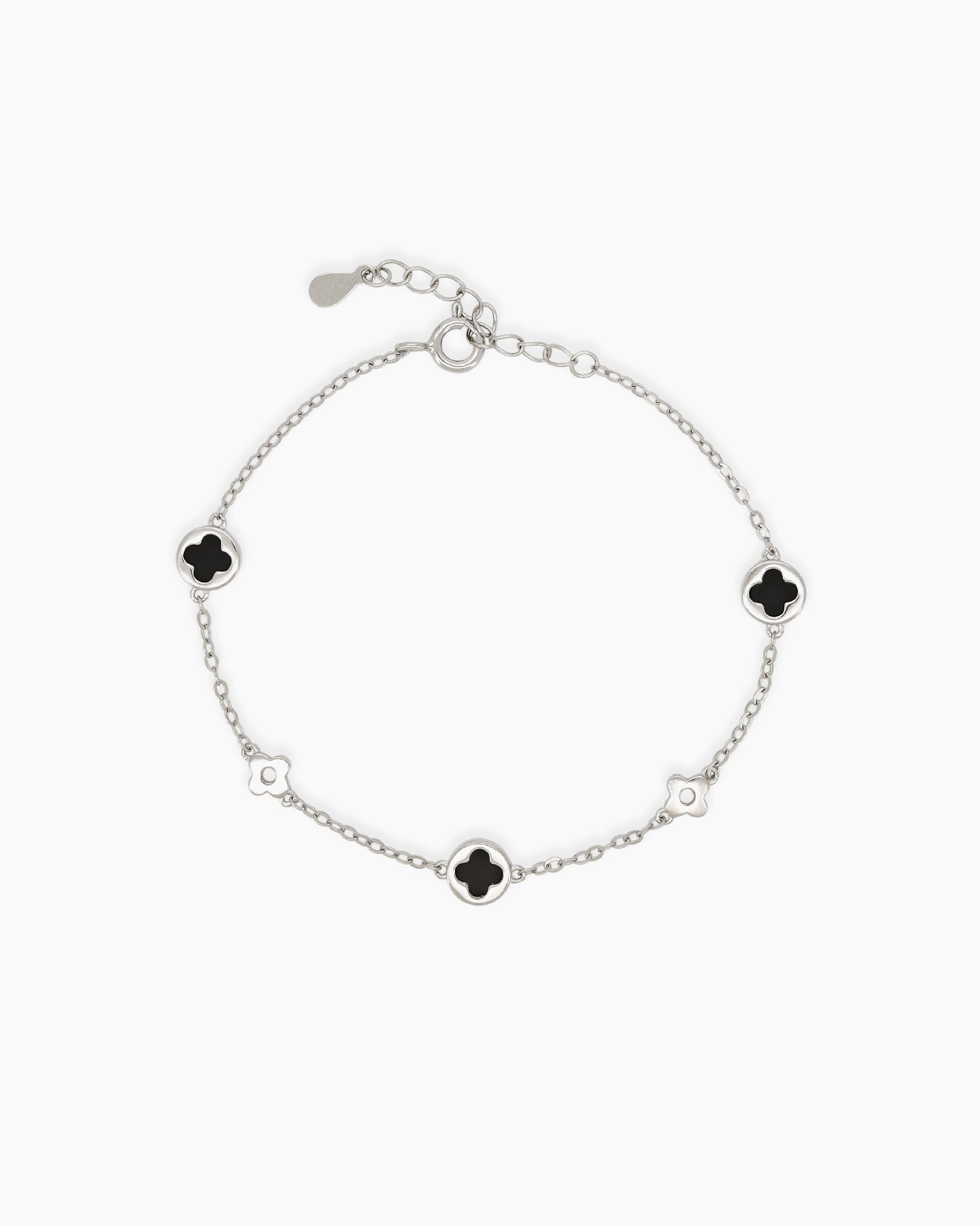A Black White Gold bracelet with smooth, glossy stones cut into an iconic four-leaf clover form