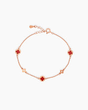 A Red Rose Gold bracelet with smooth, glossy stones cut into an iconic four-leaf clover form