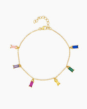 A gold bracelet with six multicolored zircon baguette-cut charms suspended on a delicate chain