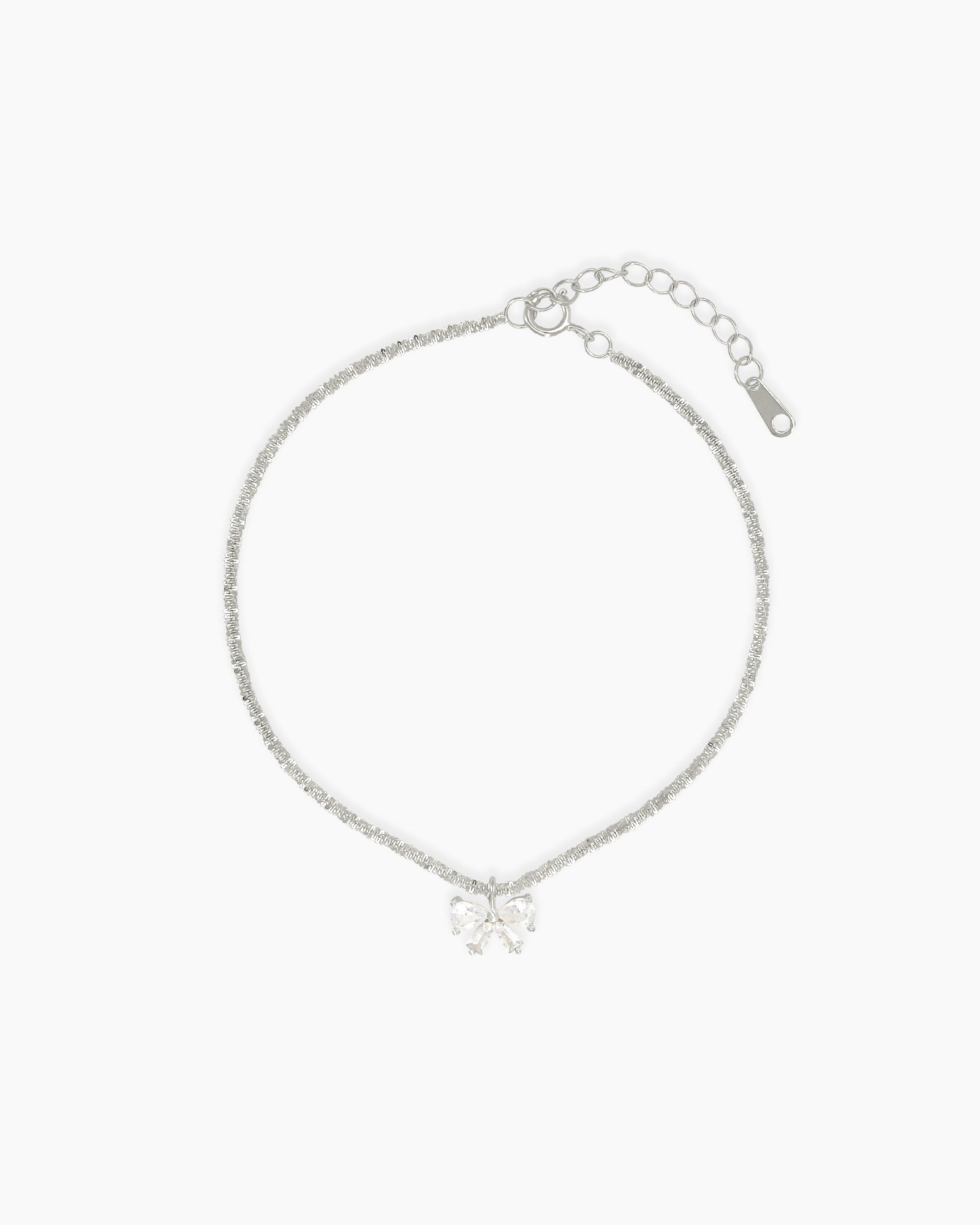 A minimalist bracelet with a shimmering diamond-cut silver chain finished with a dainty zircon bow