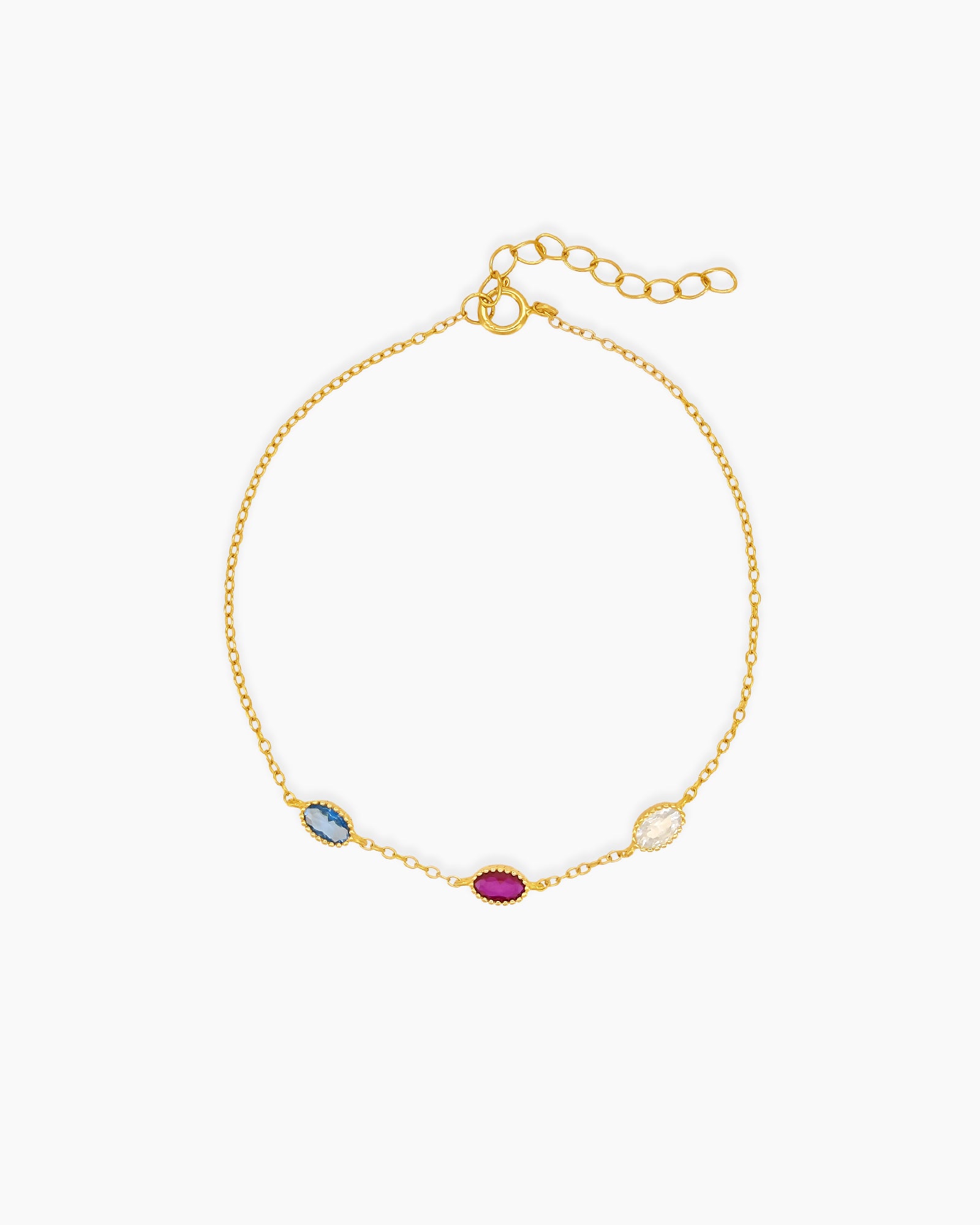 An elegant bracelet with three bezel-set oval zircons, each in a unique hue, on a fine cable chain