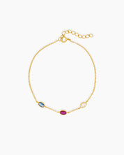An elegant bracelet with three bezel-set oval zircons, each in a unique hue, on a fine cable chain
