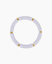A playful lilac bangle with smooth, curved acrylic segments and delicate golden connectors