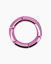 A radiant pink bangle with a sleek tubular silhouette and a high-shine metallic finish