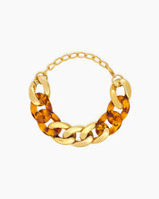 A bold leopard bracelet with chunky marbled acrylic links intertwined with high-shine gold-tone metal