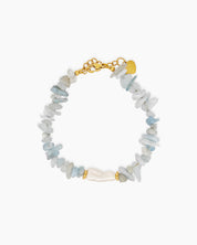 A bracelet of natural light-blue quartz chips, anchored by a luminous baroque pearl at its center