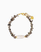 A bracelet of natural brown quartz chips, anchored by a luminous baroque pearl at its center