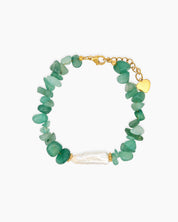 A bracelet of natural green quartz chips, anchored by a luminous baroque pearl at its center