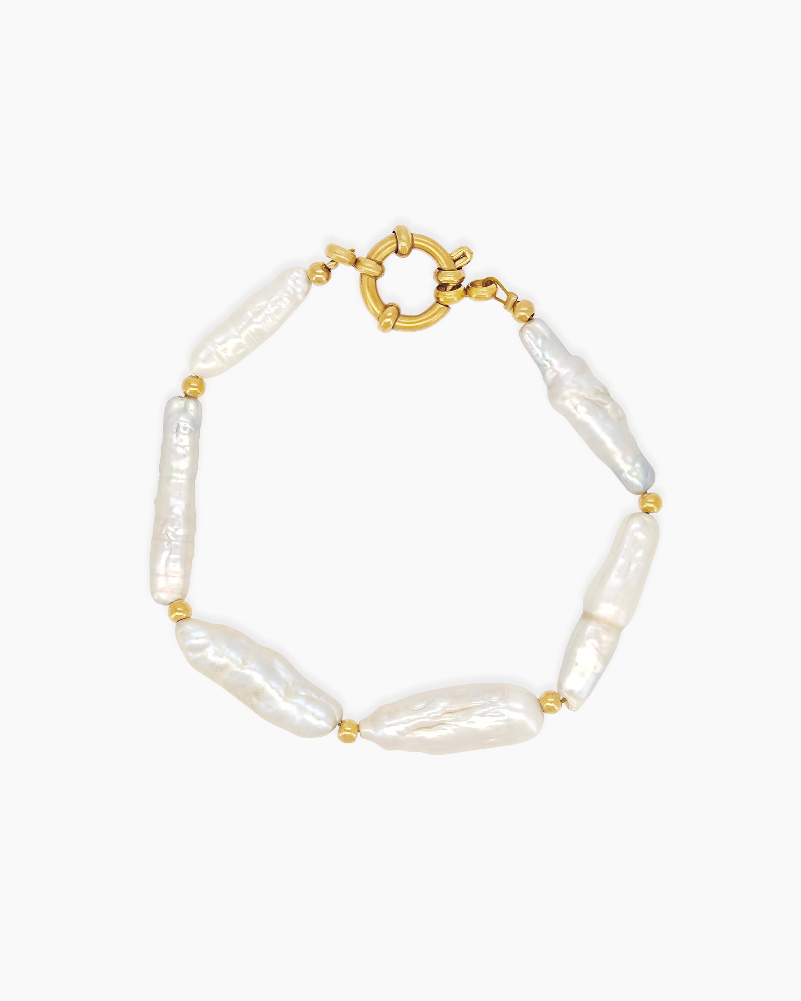 A bracelet of elongated baroque pearls with soft, iridescent sheen, accented by delicate gold-toned beads