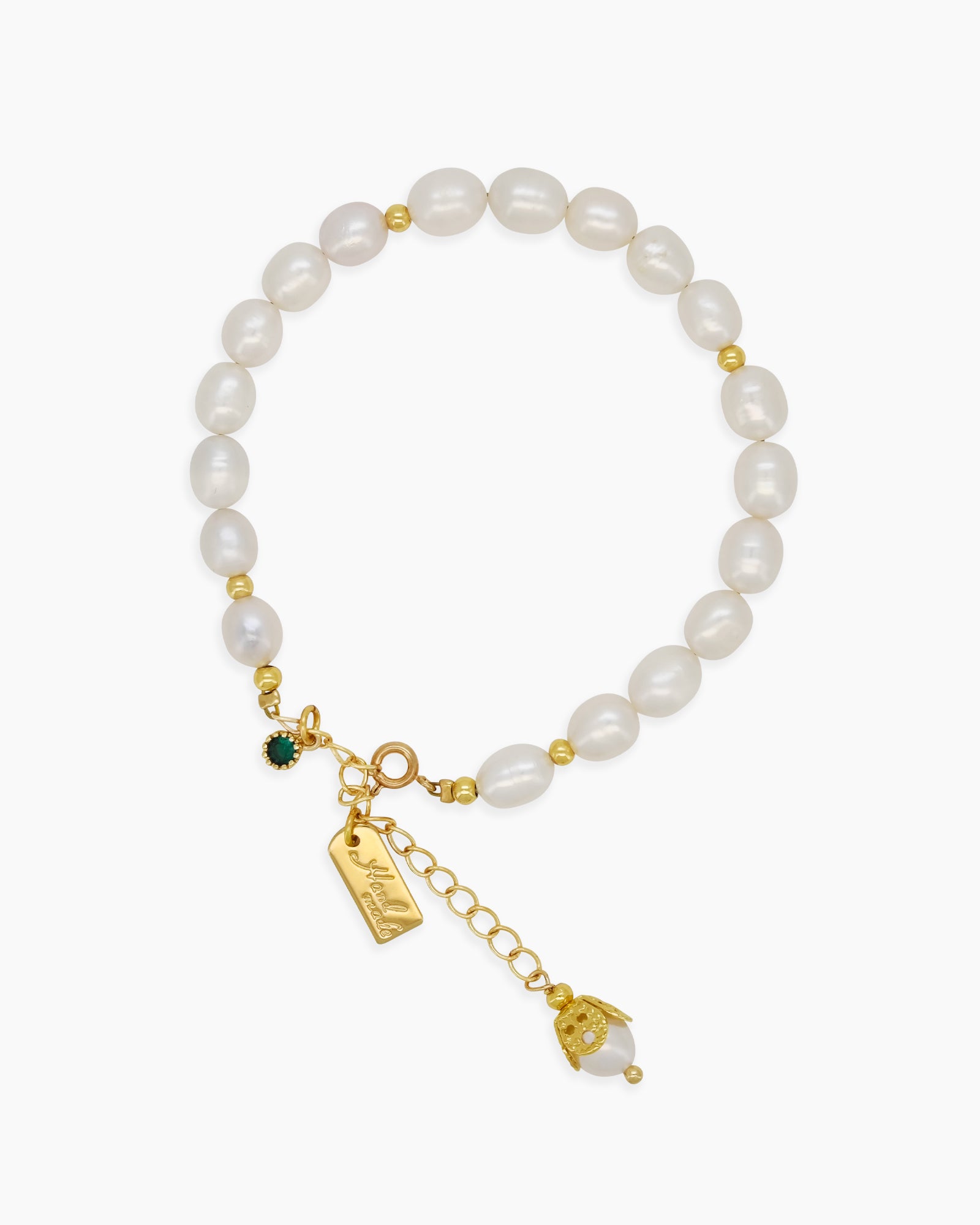 A bracelet of lustrous freshwater pearls and polished gold-toned beads with a trio of statement charms
