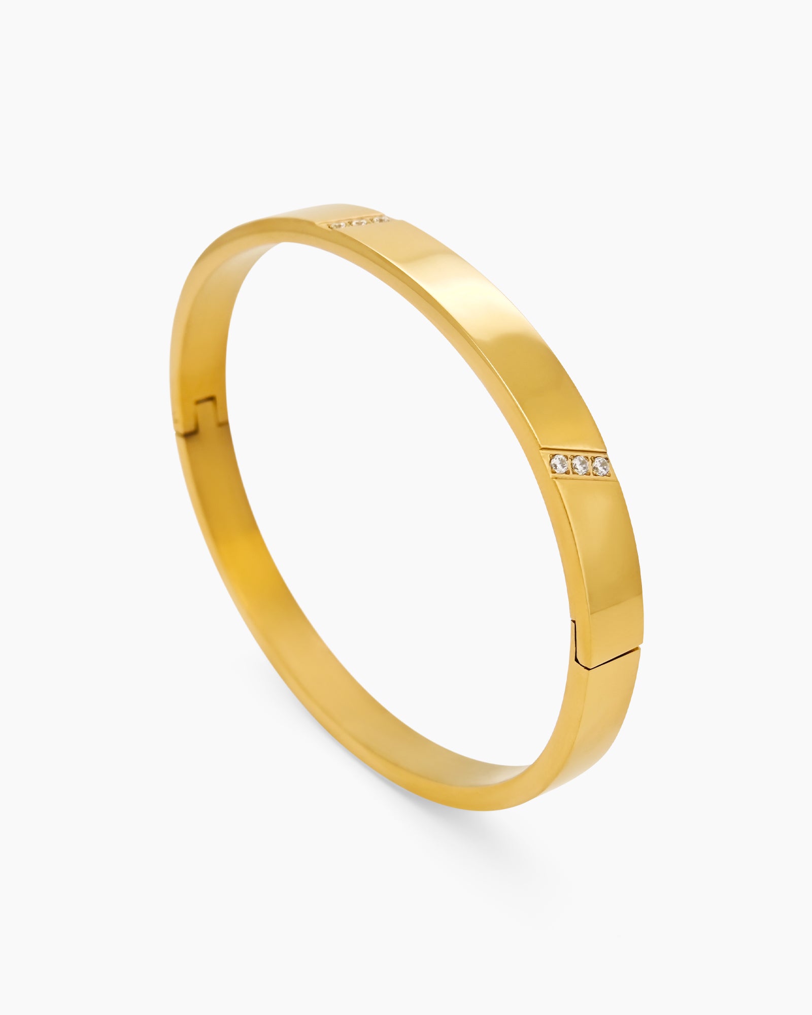 A gold-plated bangle with slim, geometric lines and delicate stone accents for a refined sparkle
