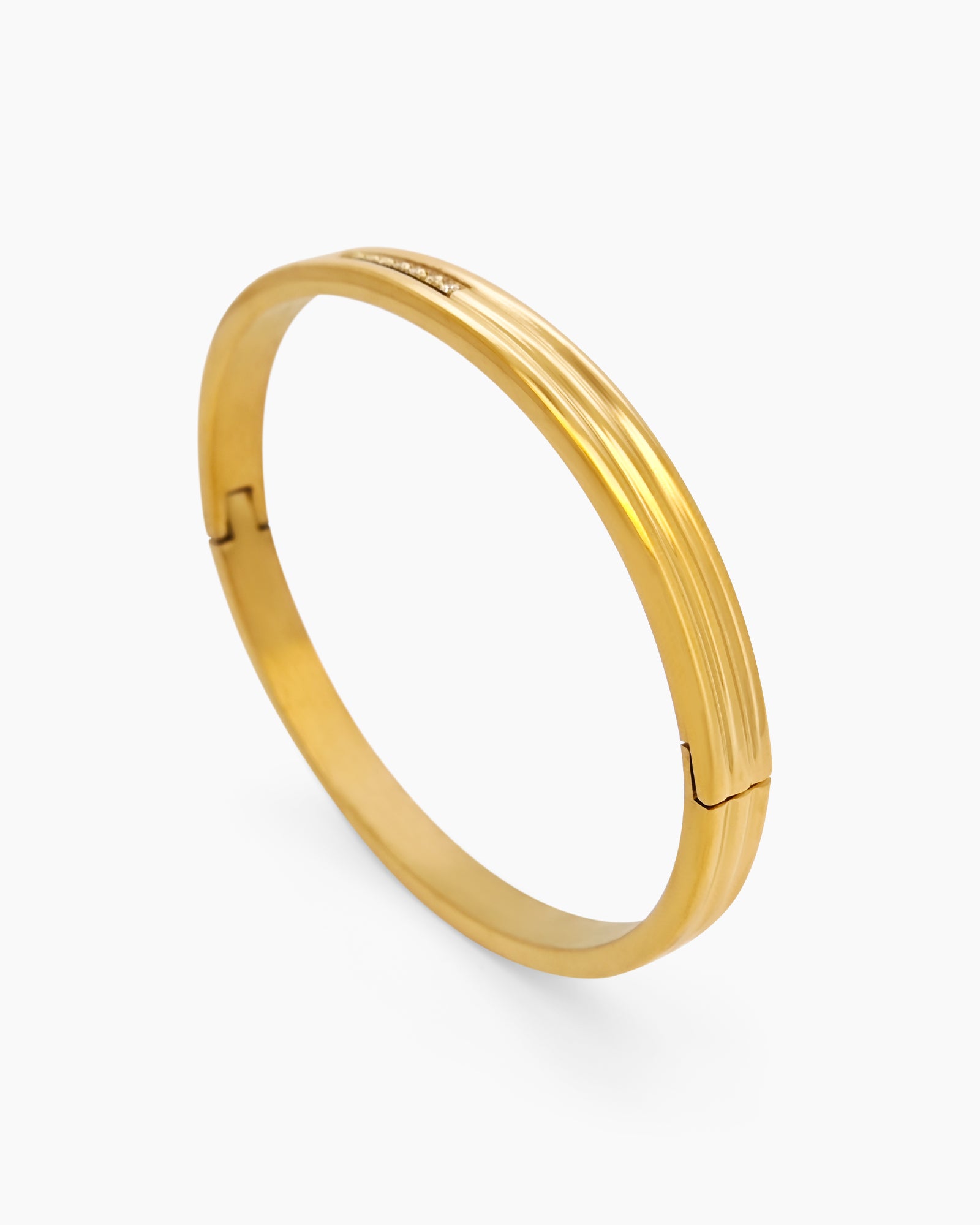 A gold-plated bangle with clean, layered lines and a central row of delicate crystals for a modern look
