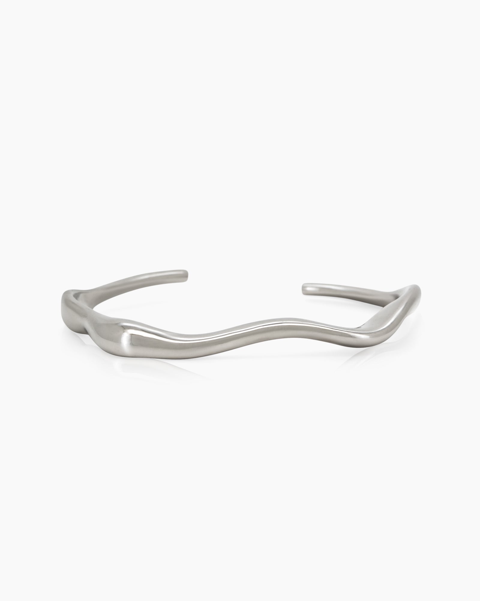 A silver open bangle with soft, wavy curves that wrap gently around the wrist for a refined look