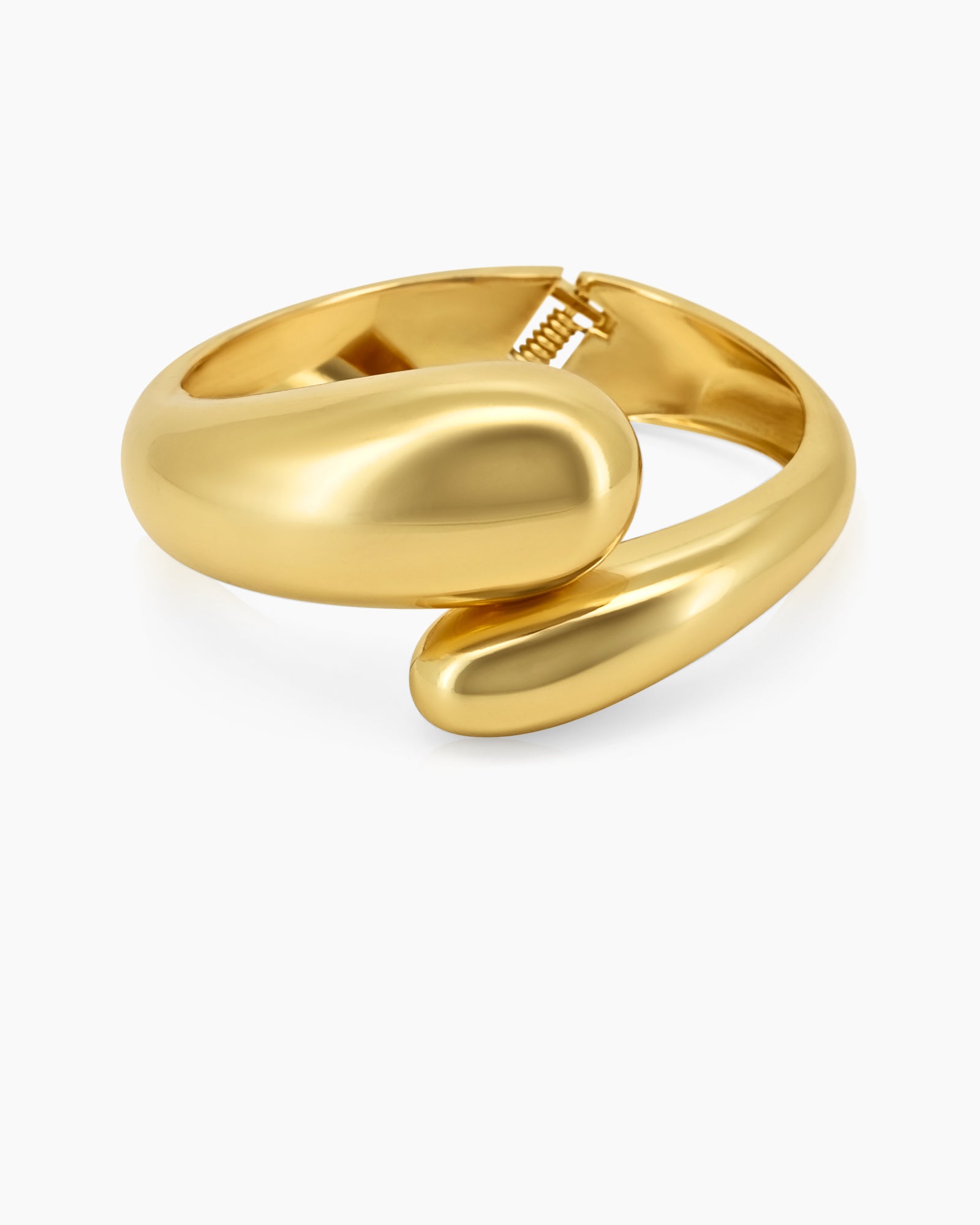 A bangle with a bold, curved silhouette, abstract overlapping shape, and a high-shine gold finish