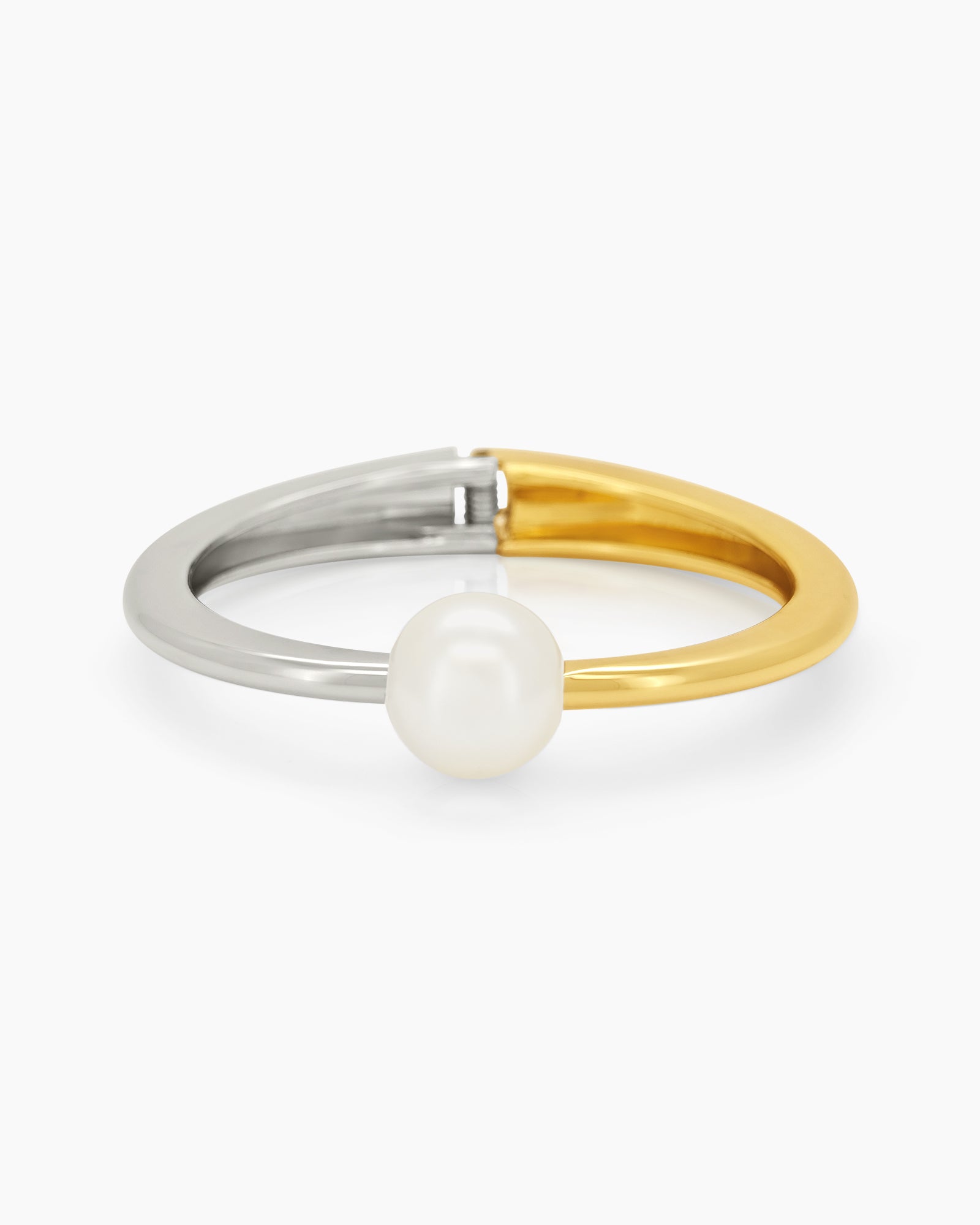 A mixed-metal hinged bangle pairing silver and gold in a seamless line, with a single pearl accent