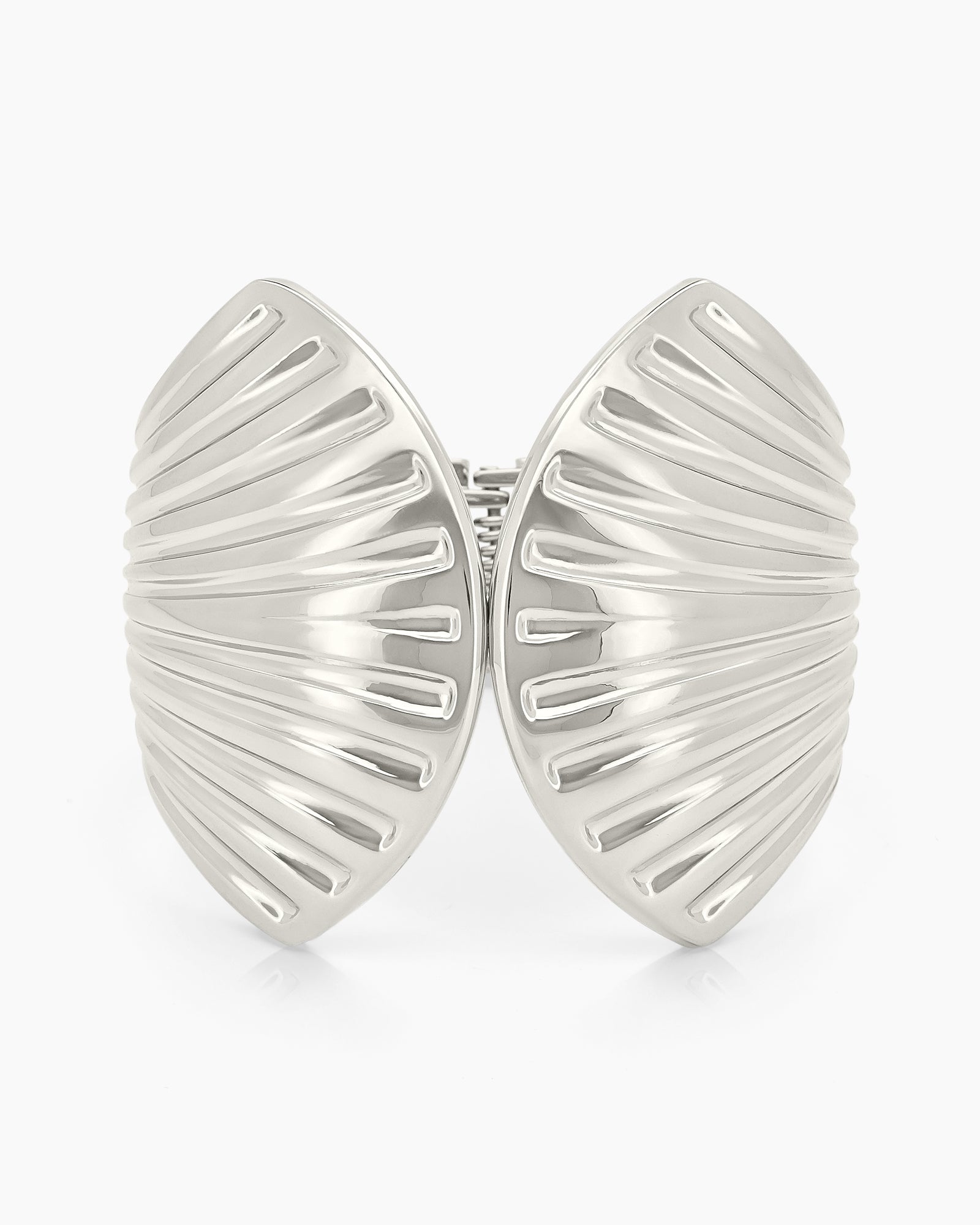 A polished silver hinged bangle sculpted with flowing, shell-inspired ridges for a bold, statement look