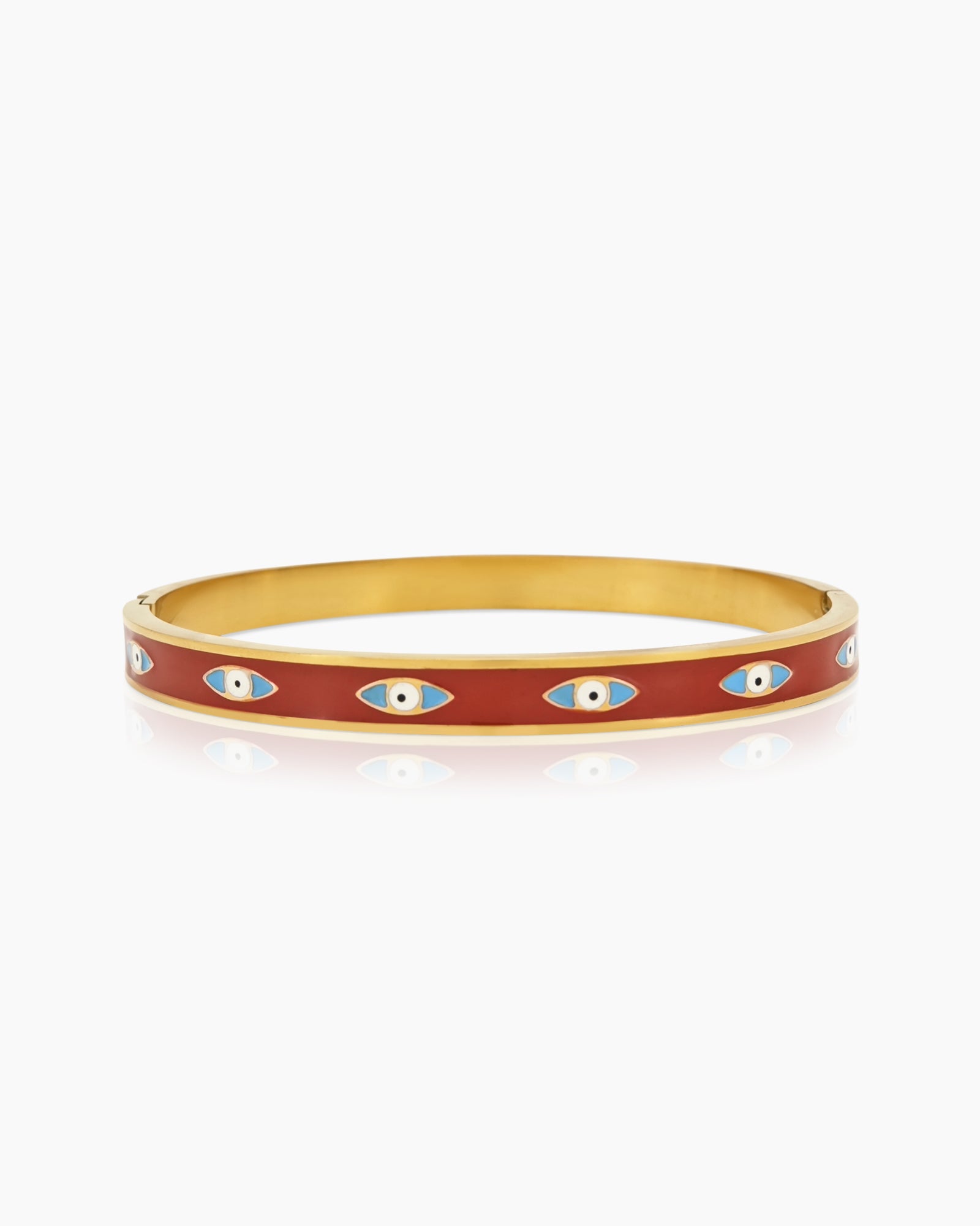 A hinged bangle wrapped in vivid red enamel, adorned with repeating sky-blue evil eye motifs