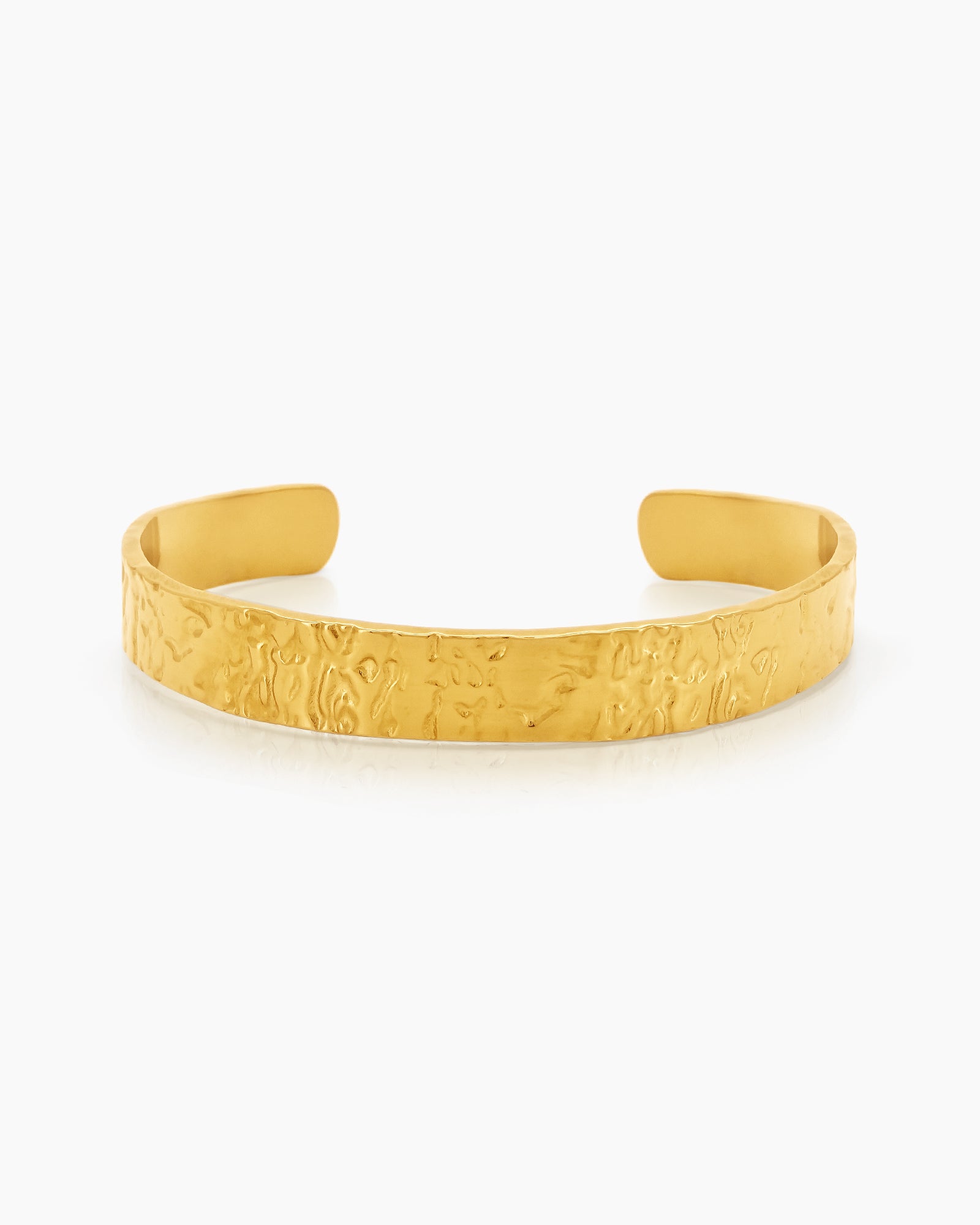 An open cuff bangle with a softly textured surface, like golden sand, for a customizable fit