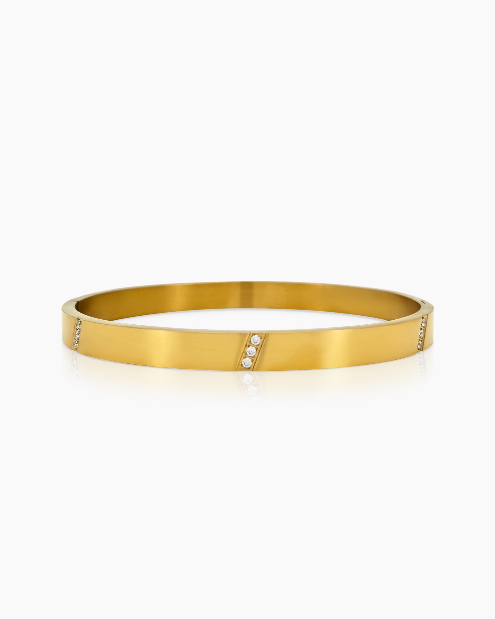 A gold-plated bangle with slim, geometric lines and delicate stone accents for a refined sparkle
