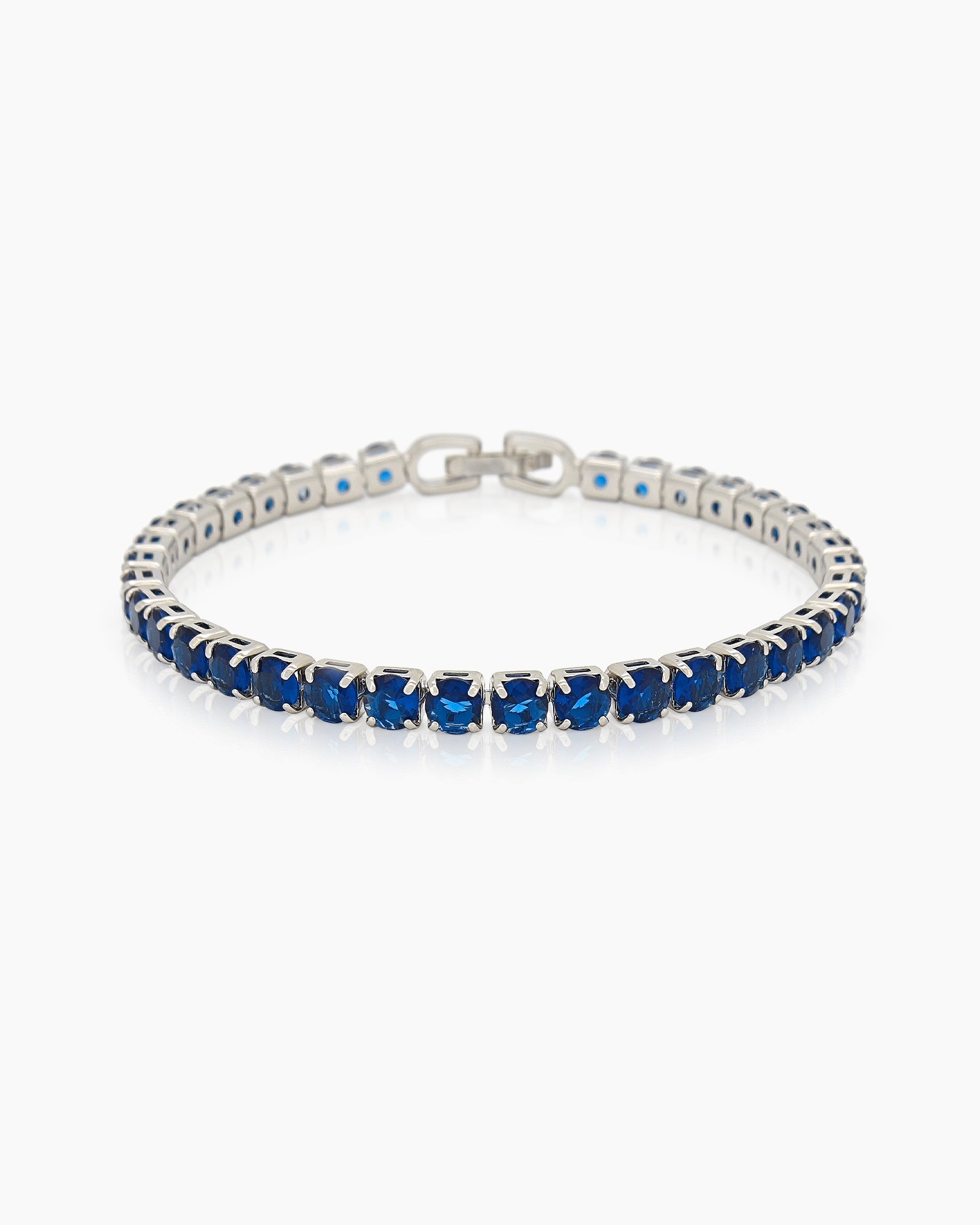 A classic tennis bracelet featuring vibrant, round-cut navy zircon stones in a sleek silver-tone channel