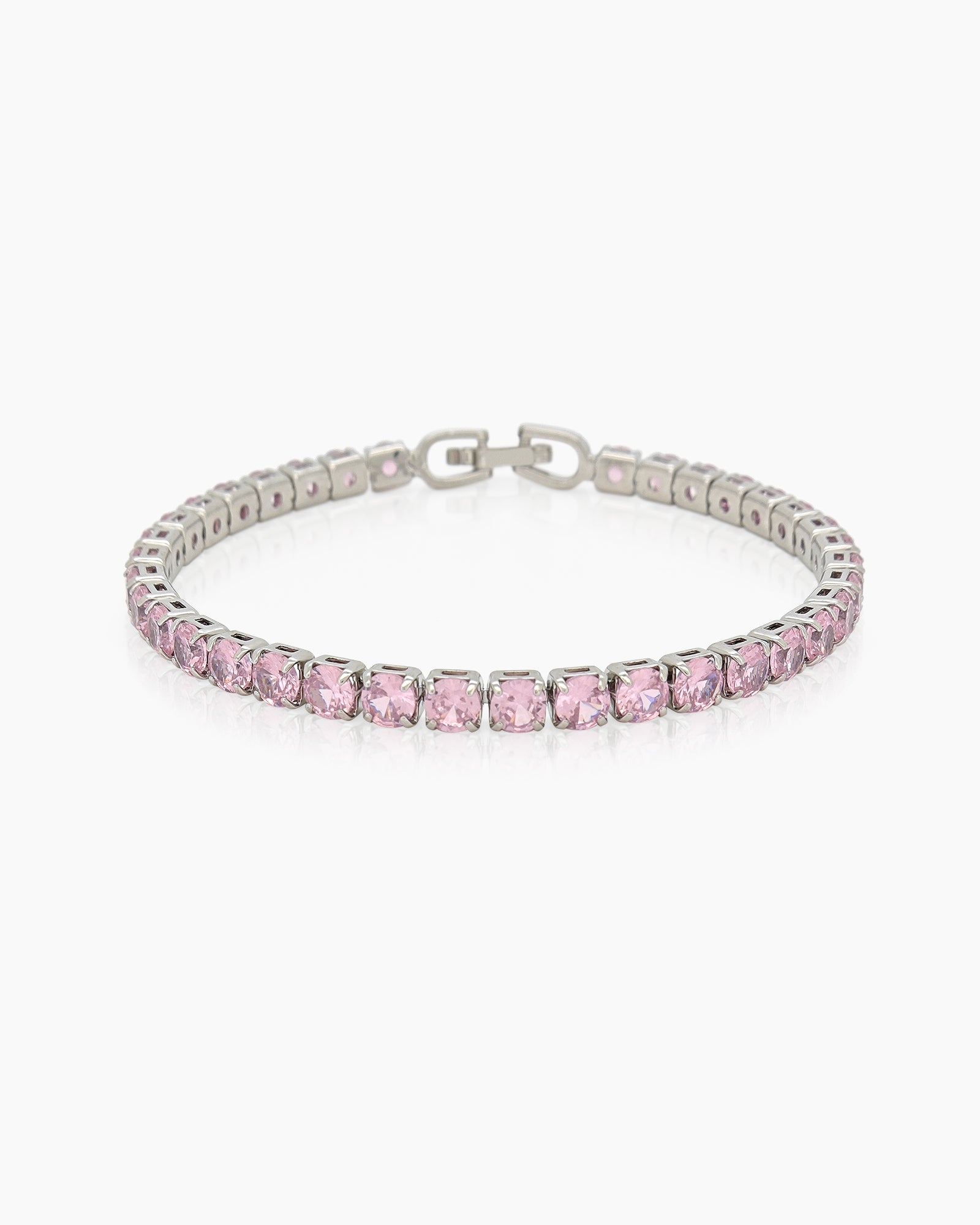 A classic tennis bracelet featuring vibrant, round-cut pink zircon stones in a sleek silver-tone channel