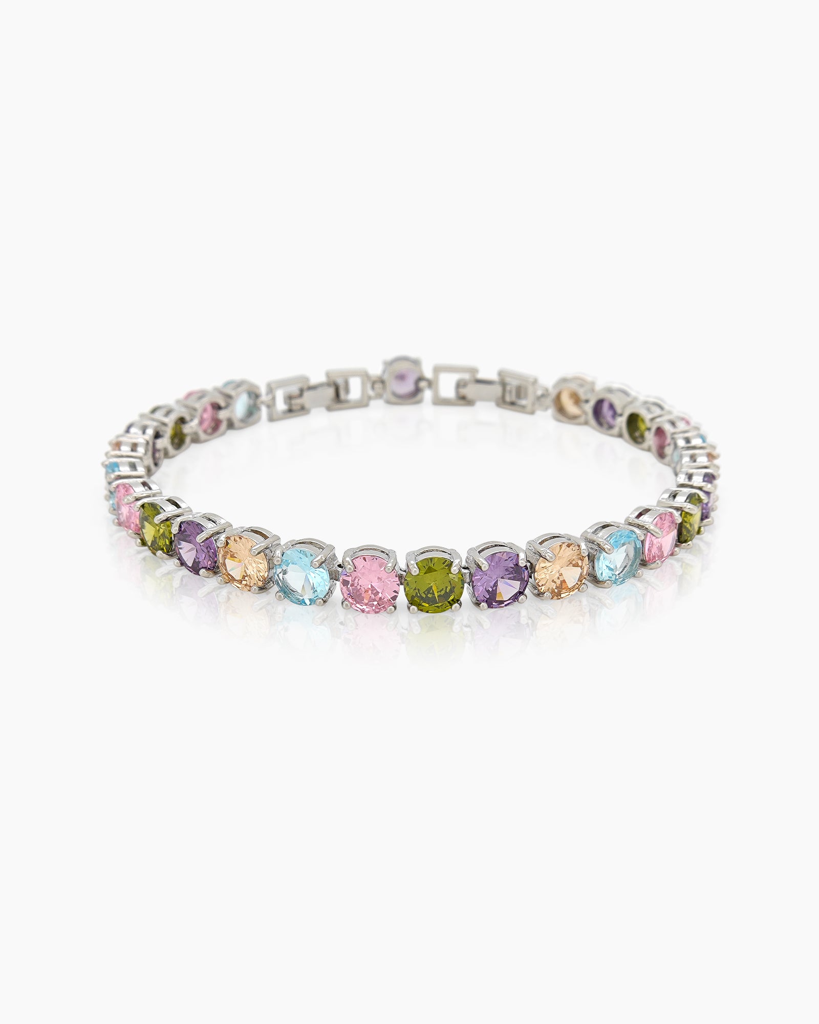 A tennis bracelet with a cheerful array of round-cut zircons in soft pastel shades and a sleek silver frame
