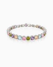 A tennis bracelet with a cheerful array of round-cut zircons in soft pastel shades and a sleek silver frame