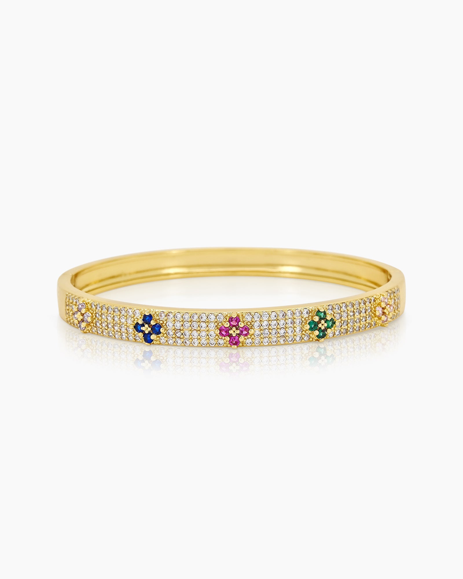A gold bangle with a sleek silhouette, adorned with pavé-set crystals and playful multicolored floral motifs