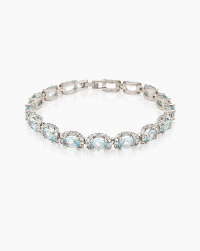 A bracelet with a row of icy-blue cushion-cut crystals, each framed in a halo of delicate zircons