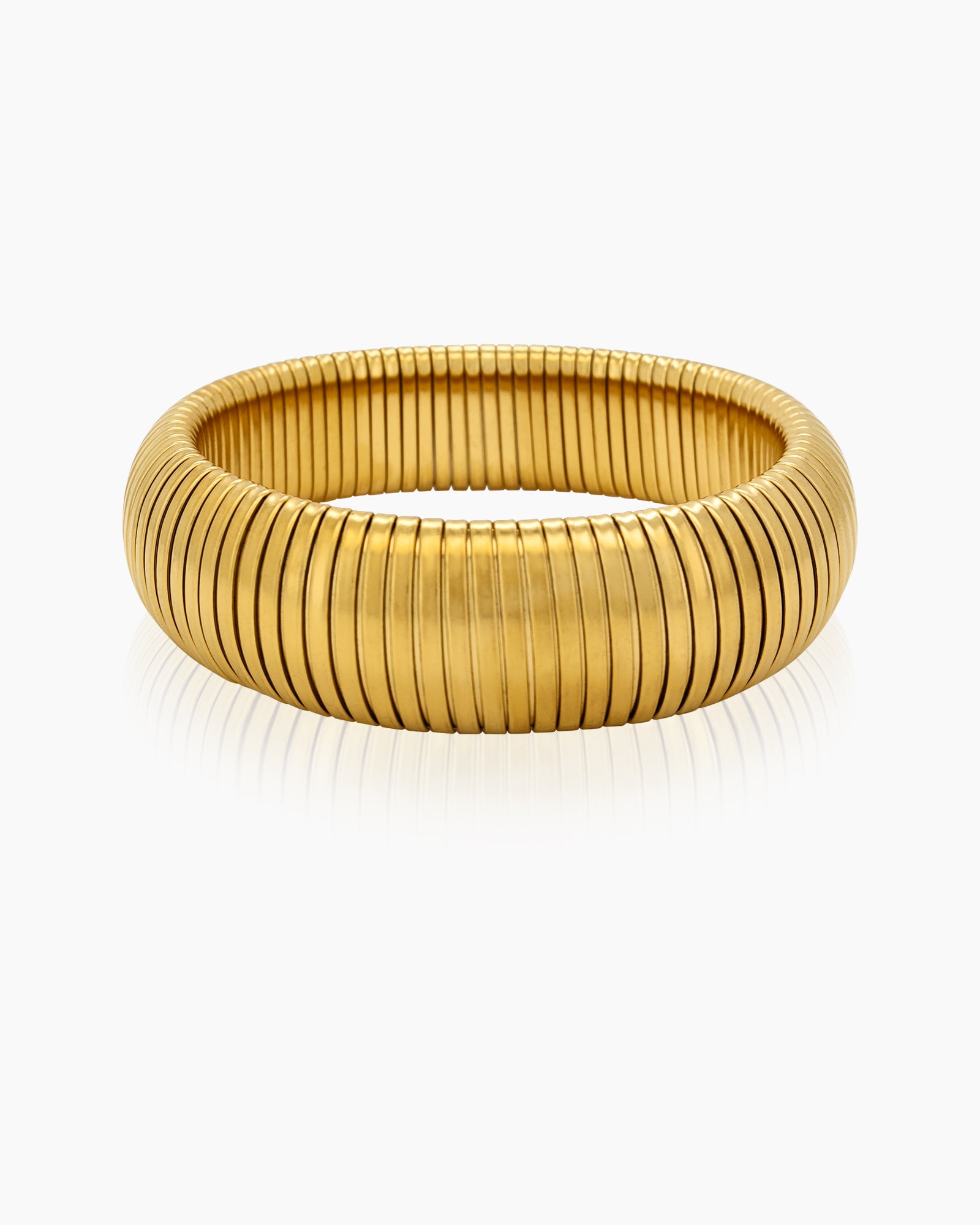 A stretch bangle with a coiled, accordion-like form and a polished gold-tone finish for a retro glow
