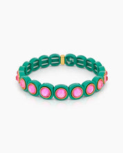 A green-pink stretch bracelet with glossy links set with iridescent crystal stones for a playful flair