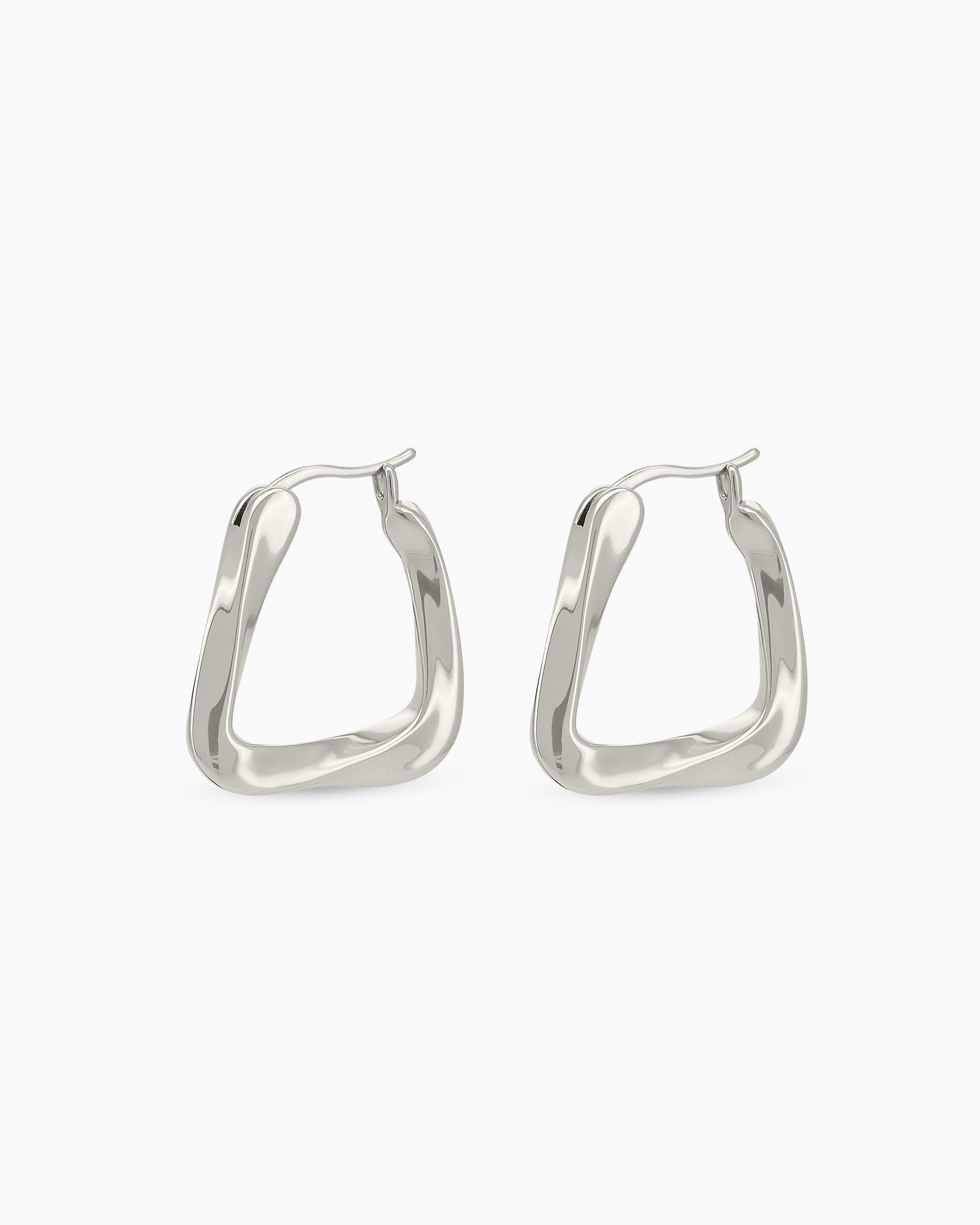 Silver hoop earrings with a bold triangular shape, softly rounded edges, and a high-shine finish