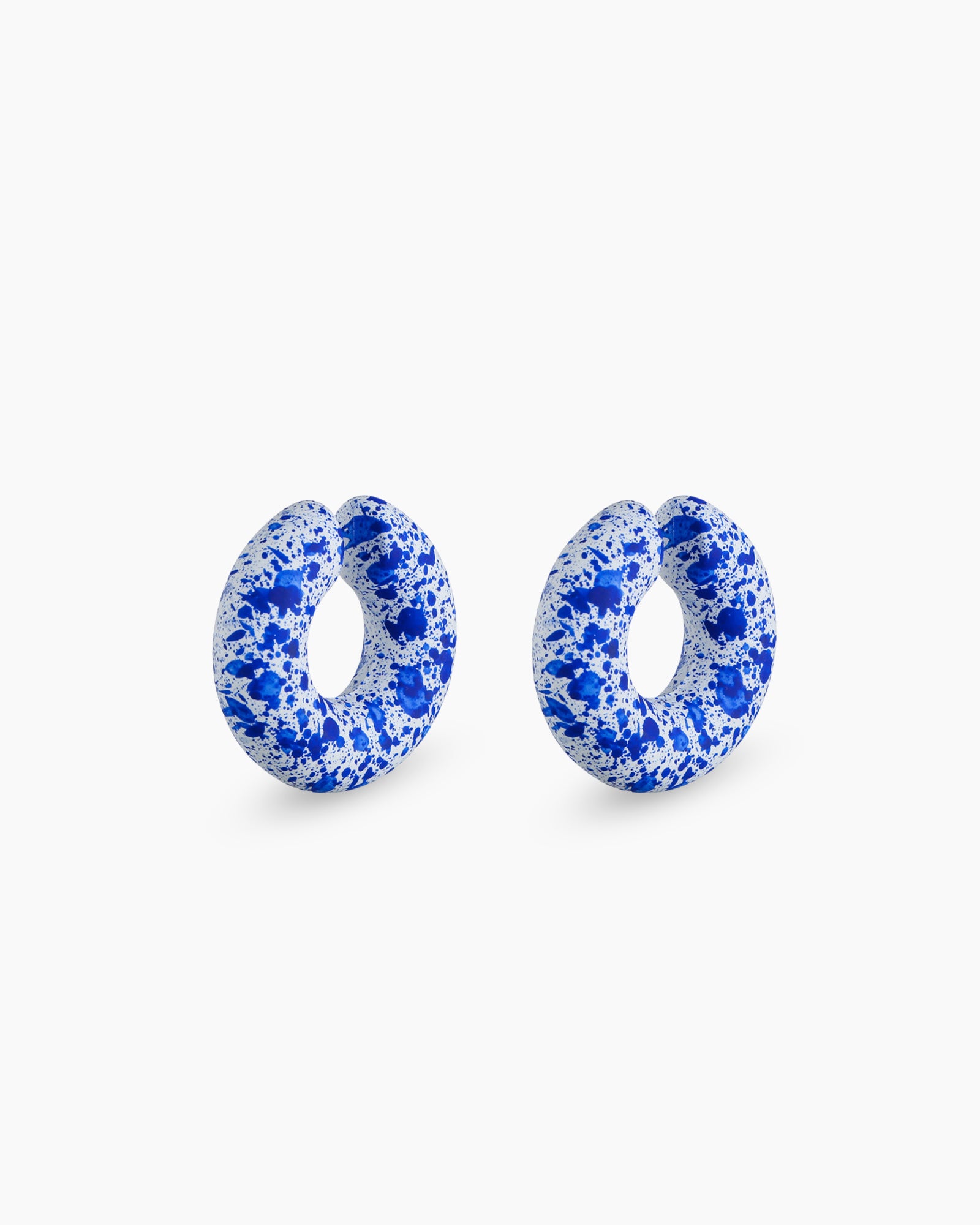 Chunky blue ear cuffs with a sculptural donut silhouette and an abstract hand-painted splatter design