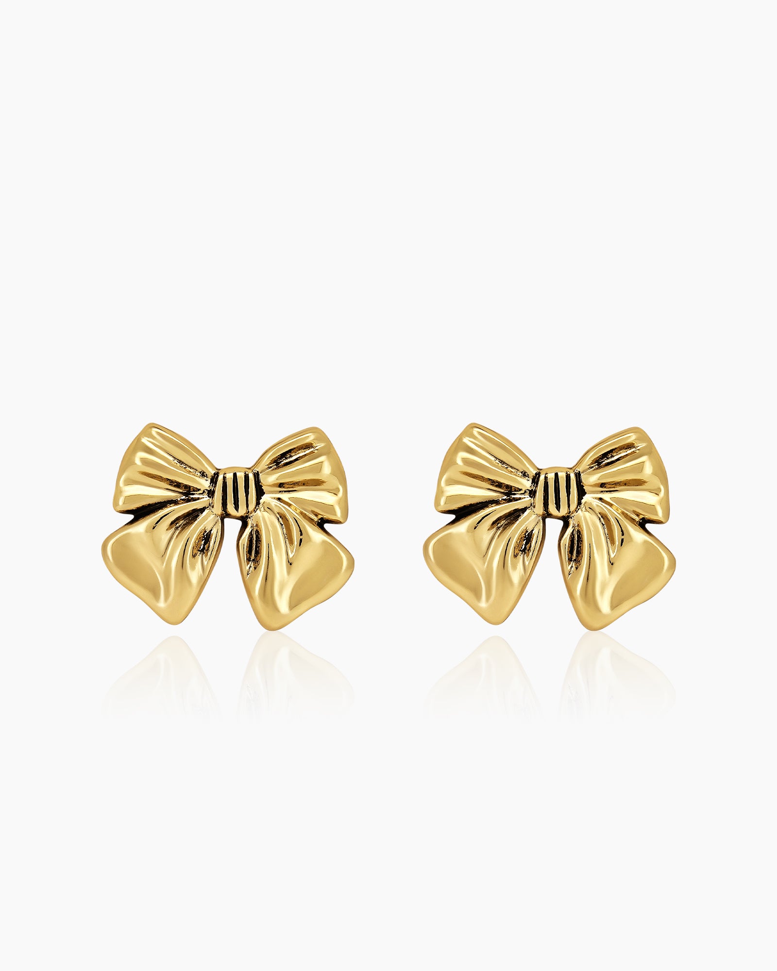 Sculptural large gold bow stud earrings with smooth curves for a playful yet refined flair