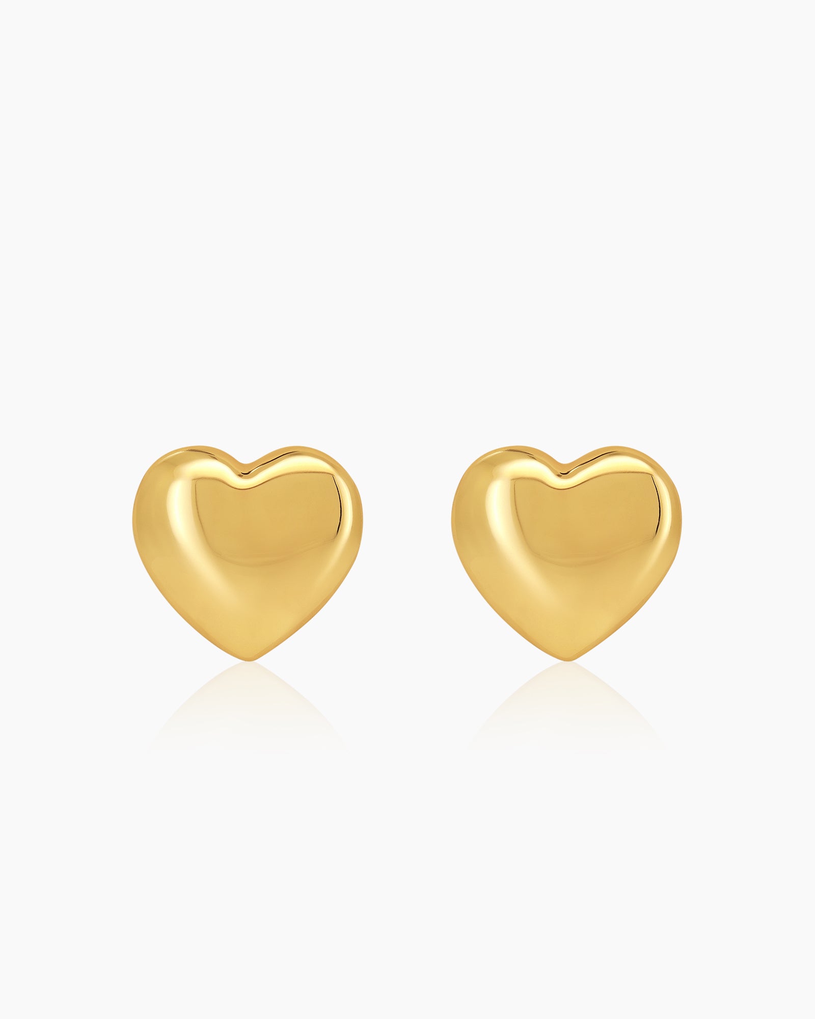 Puffed heart stud earrings with a smooth, softly rounded silhouette and a modern, glossy gold-tone finish