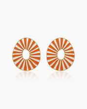 Orange oval earrings with radiant enamel stripes in a sunburst pattern for a retro glamour look