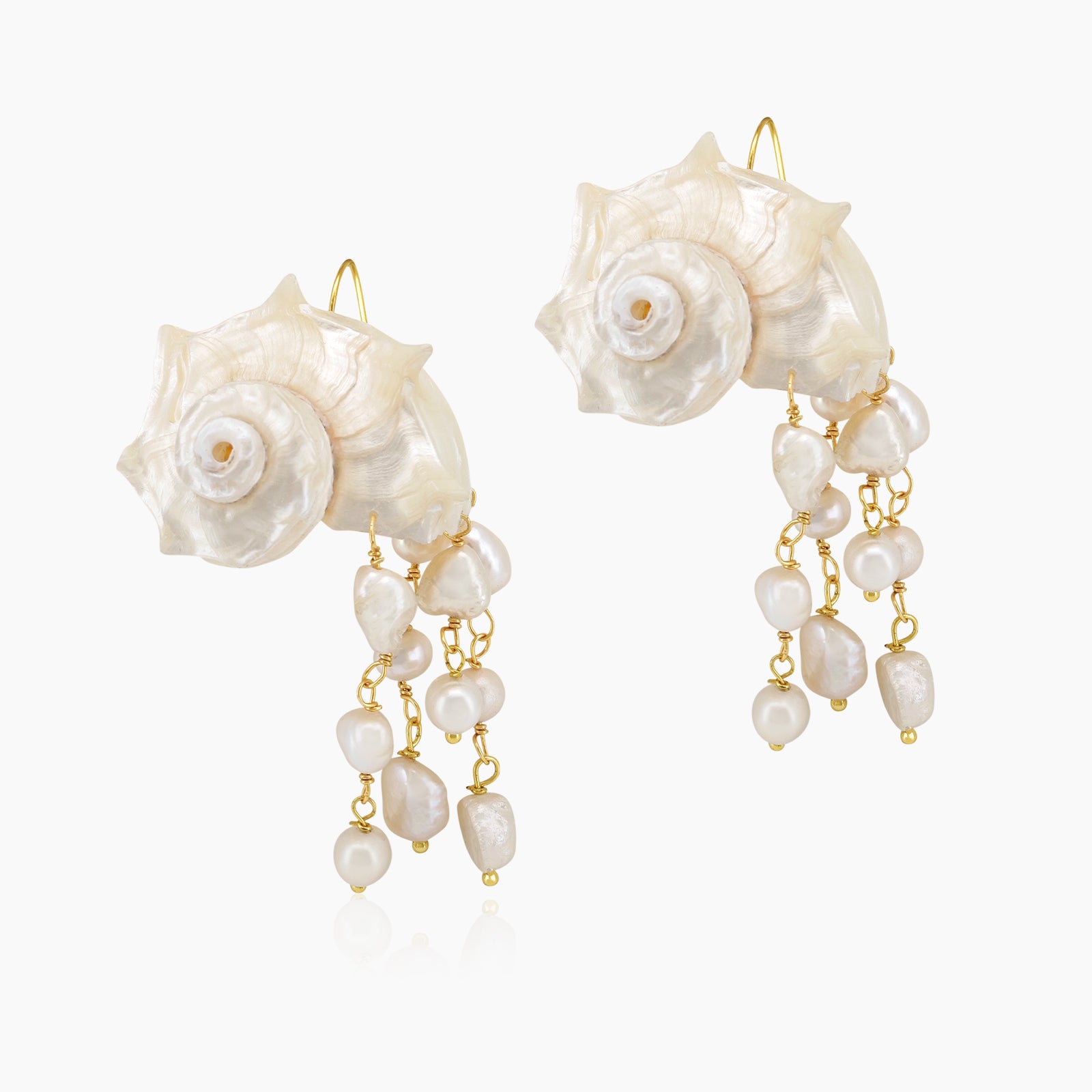 Statement earrings with sculpted conch shells and cascading strands of luminous freshwater pearls