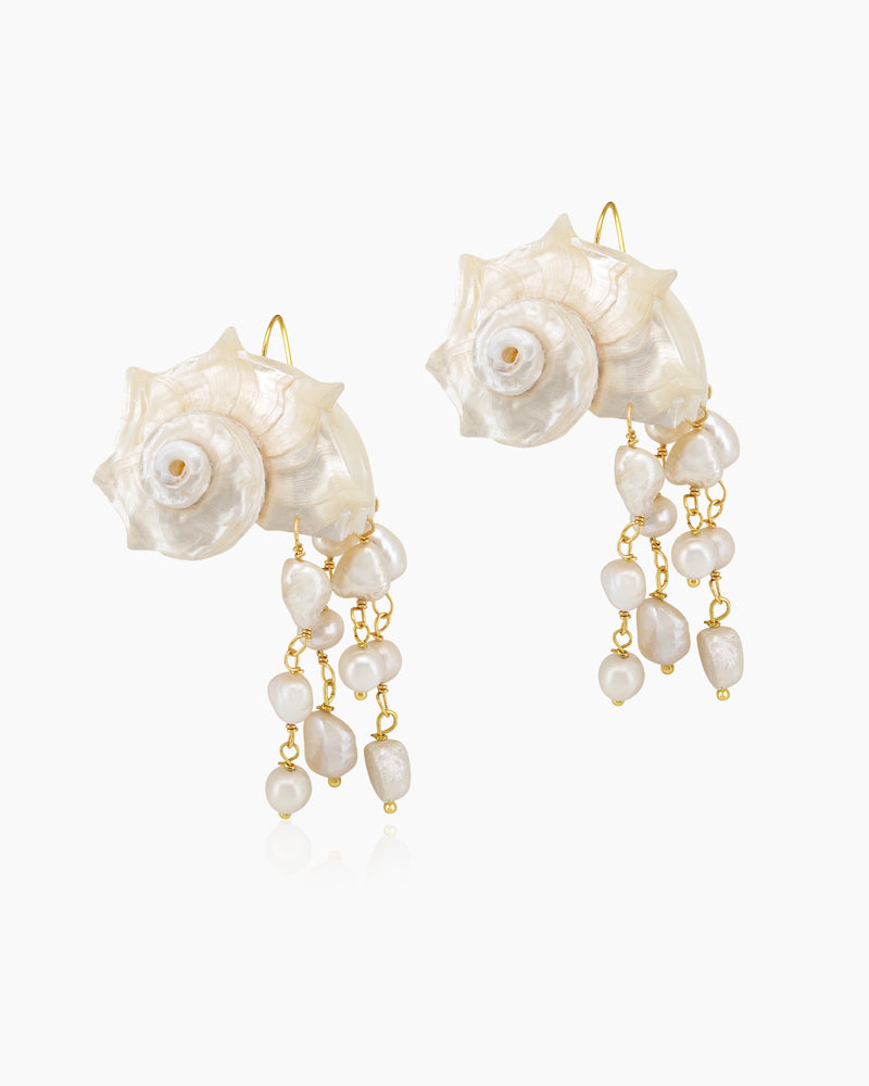 Statement earrings with sculpted conch shells and cascading strands of luminous freshwater pearls