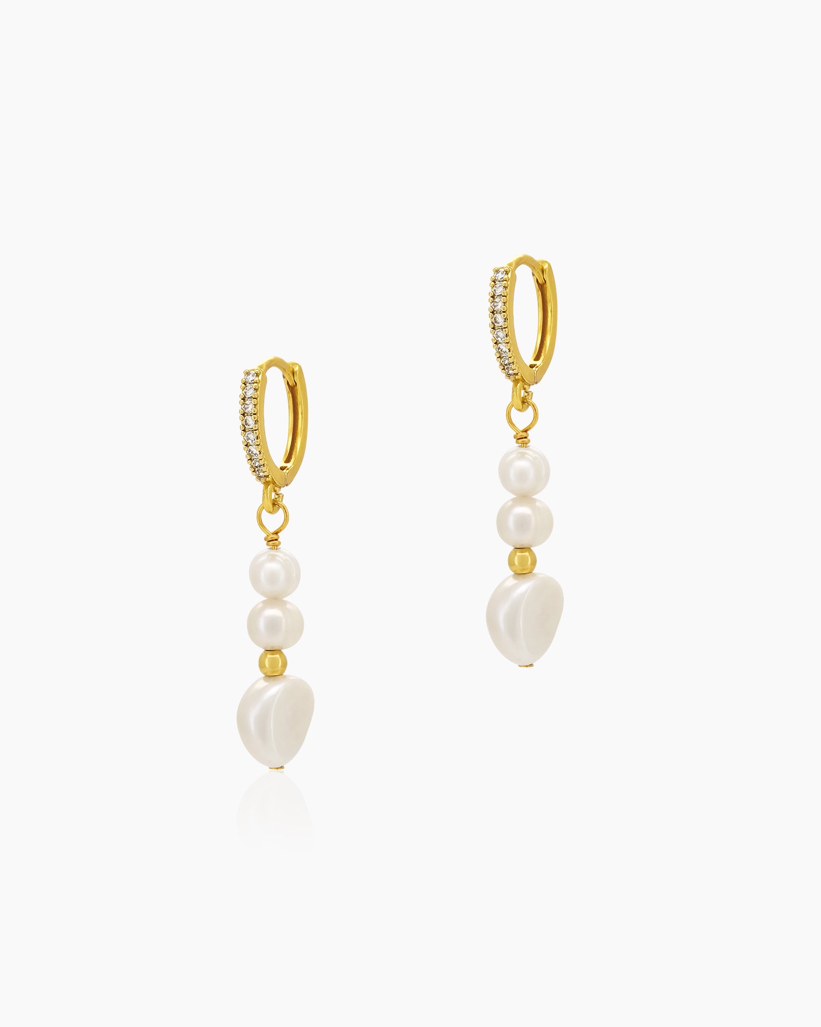 Drop earrings with a cascade of luminous pearls and golden accents, suspended from pavé-studded huggies