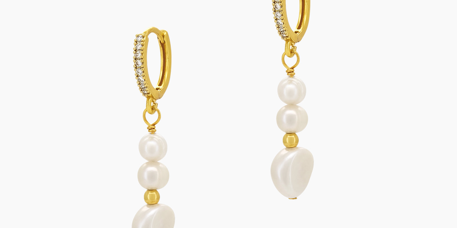 Drop earrings with a cascade of luminous pearls and golden accents, suspended from pavé-studded huggies