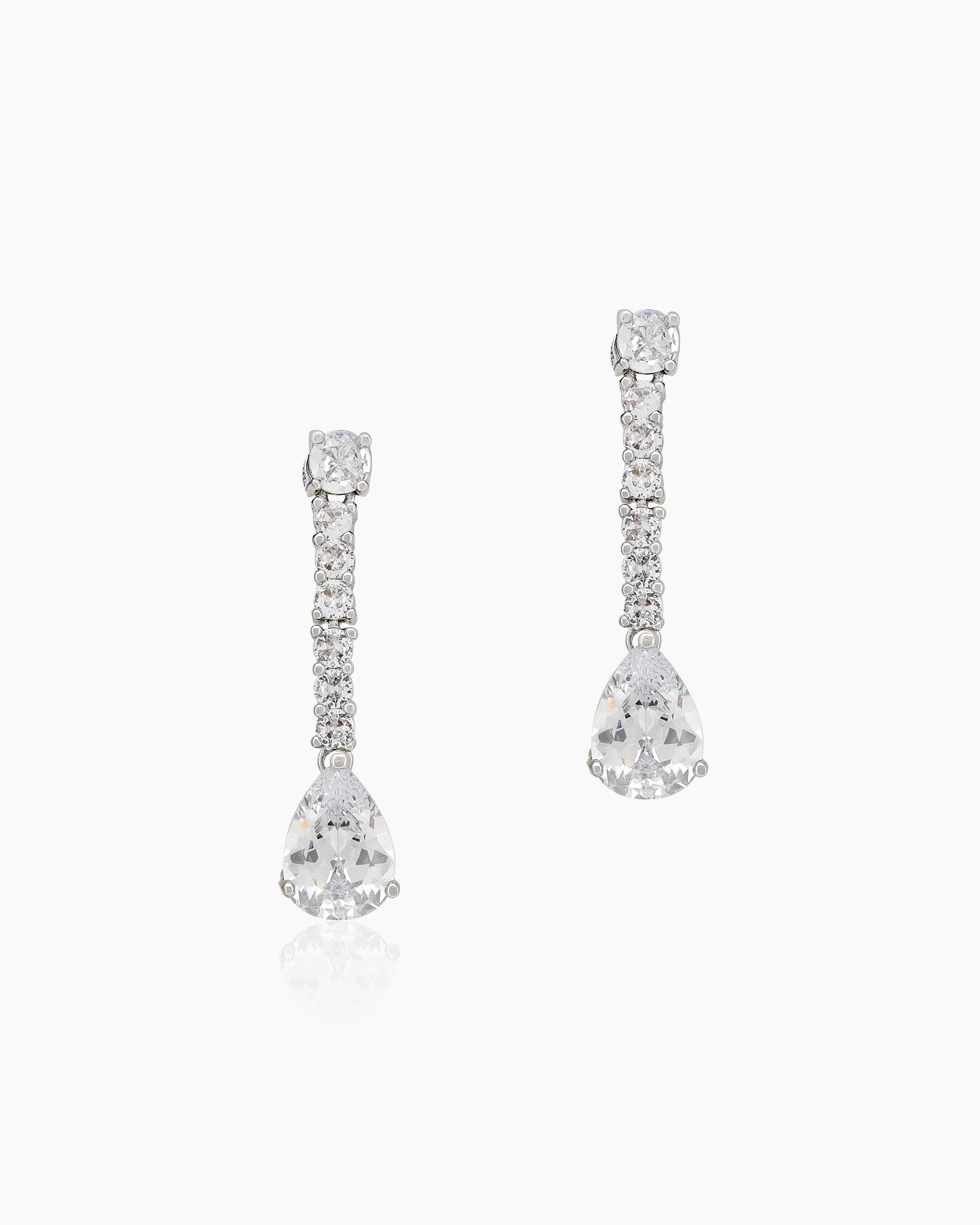 Earrings with a string of brilliant round stones descending into a luminous, suspended teardrop cut zircon