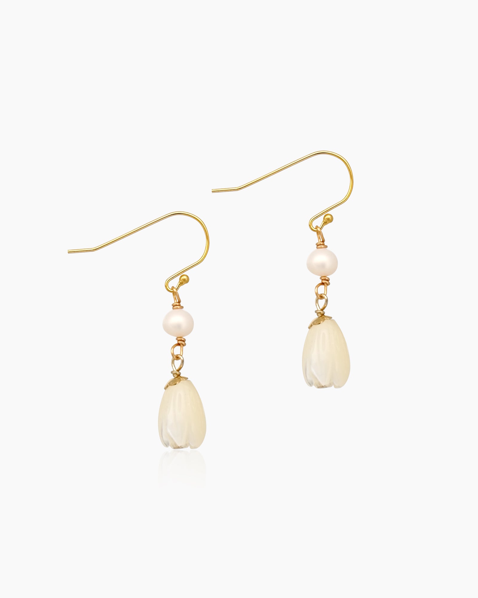 Earrings with mother-of-pearl floral drops that sway gently beneath a dainty freshwater pearl