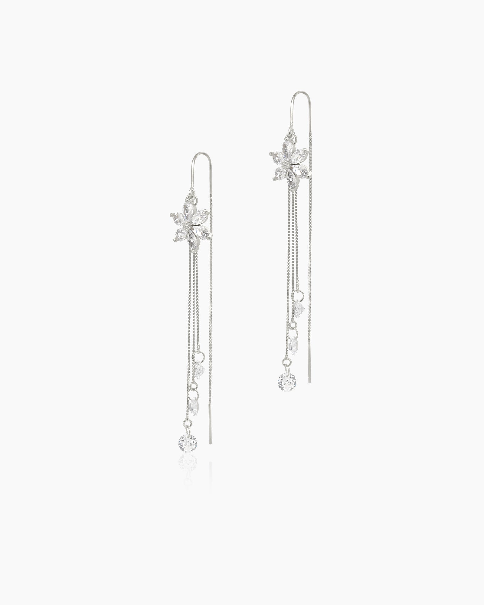 White tassel earrings with white-hued zircon blossoms and cascading silver-tone chains