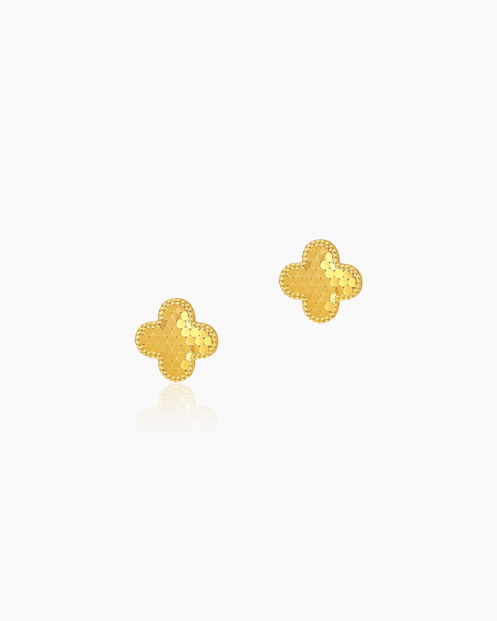 Gold stud earrings in an iconic four-leaf clover silhouette with a textured, faceted surface