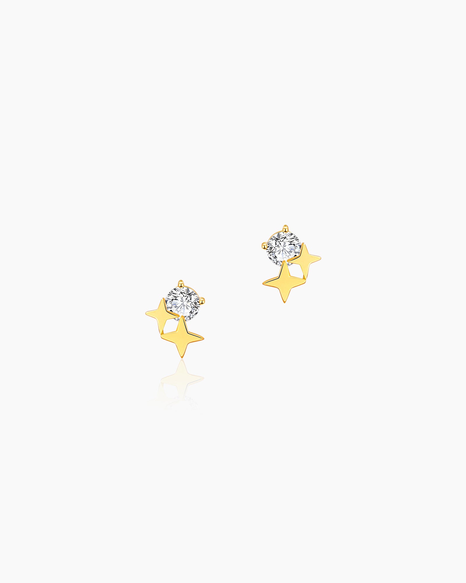 Star stud earrings with a brilliant zircon and two golden stars in a playful, celestial arrangement