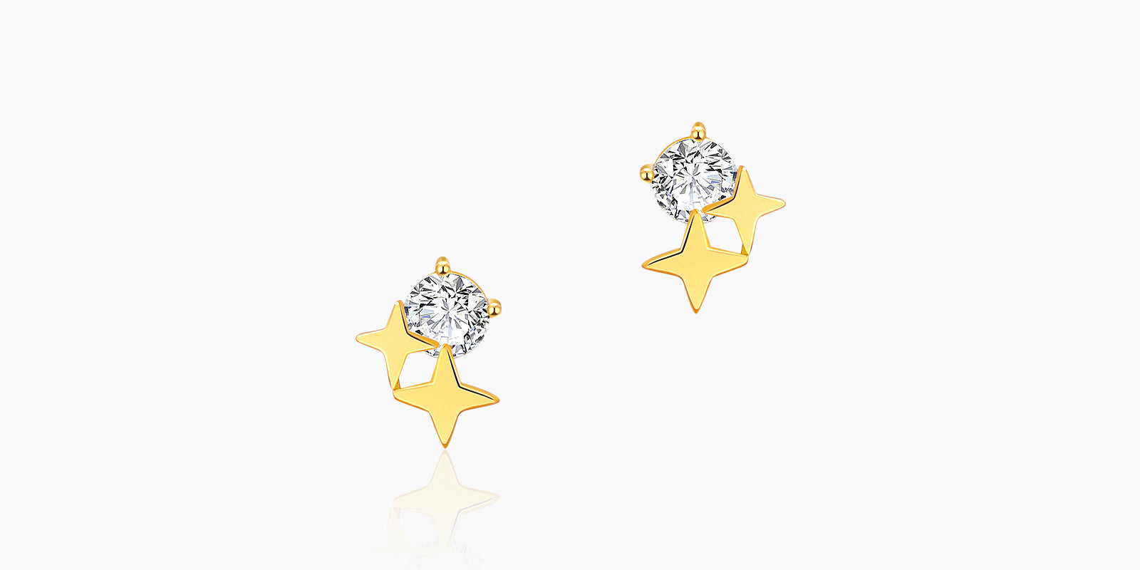 Star stud earrings with a brilliant zircon and two golden stars in a playful, celestial arrangement