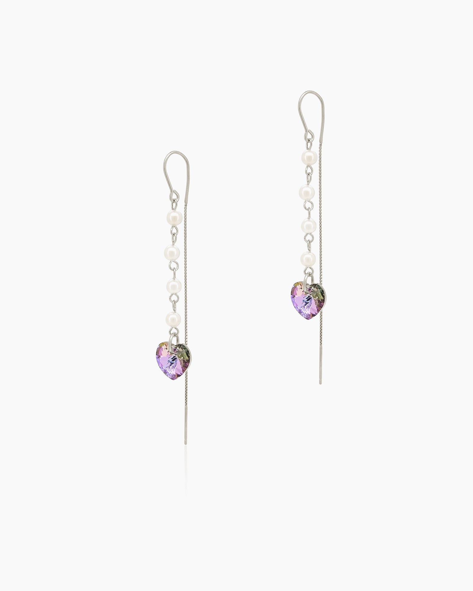 Earrings with a cascade of round faux pearls and delicate box chains ending in iridescent heart crystals