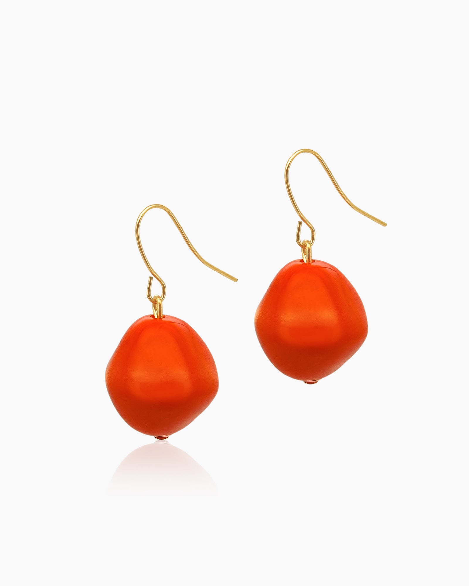 Earrings with glossy, pebble-shaped resin beads in a rich mandarin hue on delicate gold-toned hooks